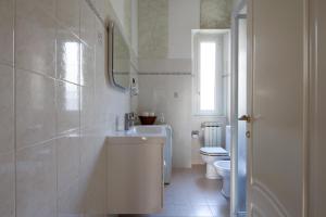 a white bathroom with a sink and a toilet at La Spezia Holidays in La Spezia