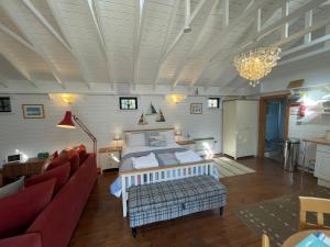 a bedroom with a bed and a couch and a table at Sailaway perfect romantic break in Norwich