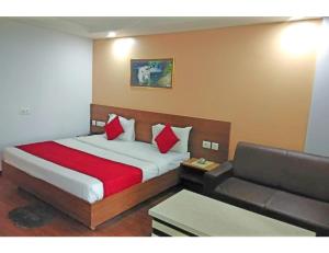 a hotel room with a bed and a couch at Hotel SPS Inn, Rewa in Rewa