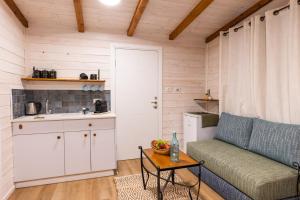 a living room with a couch and a table at אצלנו בחצר in Avnei Eitan