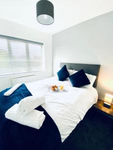 a large white bed with a plate of food on it at HU-Thirteen Apt Two- Sleeps 4 in Hessle