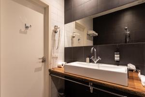a bathroom with a white sink and a mirror at Weber Studios in Amsterdam