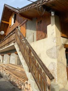a house with a wooden staircase in front of it at Sous l'Alpette en Chartreuse in Saint-Pierre-dʼEntremont