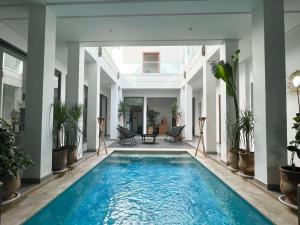 an indoor pool in a house with plants at Riad Dar DARRE in Marrakesh