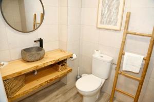 a bathroom with a toilet and a sink at M&C Penthouse Santa Barbara in Alicante +18 photos