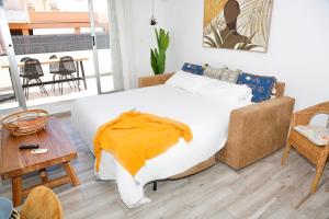 a bedroom with a large bed and a couch at M&C Penthouse Santa Barbara in Alicante