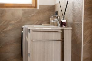 a small cabinet in a bathroom with at BAITA NOEMI in Livigno
