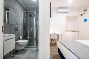 a bathroom with a shower and a toilet and a sink at Lizbon South Bed in Barreiro +26 photos