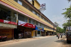 a group of buildings on the side of a street at deb Guest House And Banquet hall in Kolkata