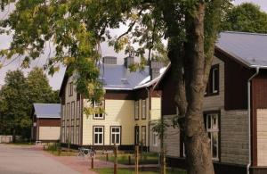 a large white house with a black roof at Dorpat Apartment in Tartu