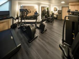 a gym with treadmills and cardio equipment in a room at Hotel Am Konzerthaus Vienna - MGallery in Vienna