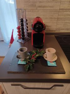 uma mesa com duas chávenas e decorações de Natal em Appartamento gaiulin em Pinzolo