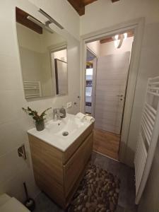 a bathroom with a sink and a mirror at Appartamento gaiulin in Pinzolo
