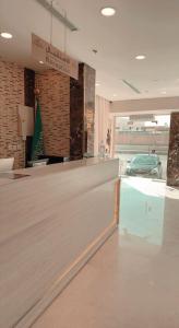 麥地那的住宿－Taj Al Eiman Hotel，商店里一张桌子和椅子的柜台