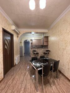 um quarto com uma mesa e cadeiras e uma cozinha em Apartment on Khimshiashvili 1 em Batumi