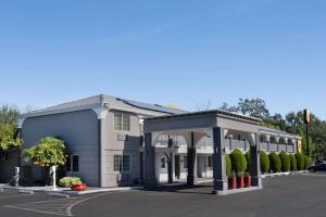 a large building with a gazebo in a parking lot at Super 8 by Wyndham Ukiah in Ukiah
