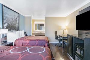 a hotel room with two beds and a flat screen tv at Super 8 by Wyndham Ukiah in Ukiah