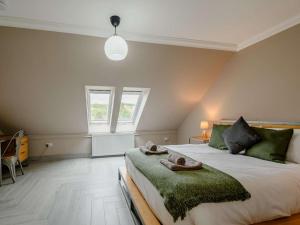 a bedroom with a bed with two towels on it at Westertonhill Lodges in Balloch