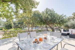 a table with plates of food on a patio at Villa Archodia - With Private Pool in Prinés