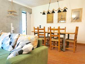 a living room with a couch and a table and chairs at Chalet Bornhome relax, sport e cultura altopiano del sole 6 ospiti - pet Frendly in Borno +33 photos