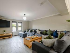 a living room with a couch and a tv at Westertonhill Lodges in Balloch
