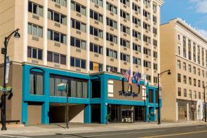 un edificio con dos banderas americanas delante de él en The Capitol Hotel, Ascend Hotel Collection en Hartford