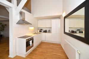 a kitchen with white cabinets and a stove at Historic Centre Apartments I in Prague