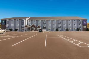 a parking lot in front of a large building at MainStay Suites Clarion, PA near I-80 in Clarion