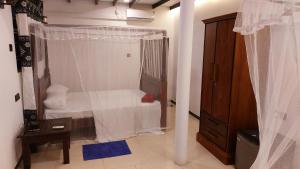 Una cama o camas en una habitación de Bandulas Beach House
