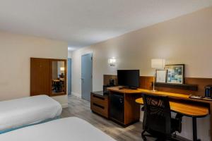 a hotel room with a bed and a desk with a computer at Comfort Inn & Suites Mt Laurel-Philadelphia in Mount Laurel