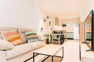 a living room with a couch and a table at APARTHOTEL SALBURUA in Vitoria-Gasteiz