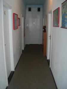 a hallway with white walls and a long hallway with white doors at Private Accommodation Raspudic in Split