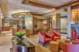 a lobby of a hotel with chairs and a waiting room at Wyndham Garden Kansas City Airport in Kansas City