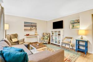 a living room with a couch and a table at Clipper Cabana Beachwalk Condo in Saint Augustine