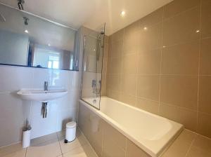a bathroom with a sink and a bath tub and a sink at 38 Zinc in Newquay