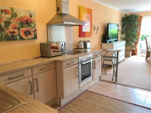 een keuken met een aanrecht met een fornuis met oven bij MEI4b Ferienwohnung Landkrebs in Niendorf