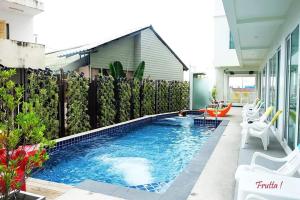 a swimming pool in the middle of a house at The Frutta Boutique in Patong Beach