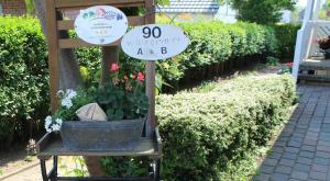 un cartello per un giardino con una pianta in un secchio di STR90b Haus Diana a Niendorf