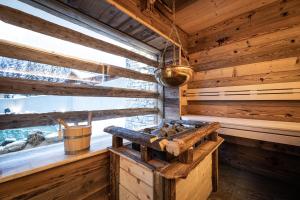 a wooden stove in a room with a window at Das Geierberg in Filzmoos