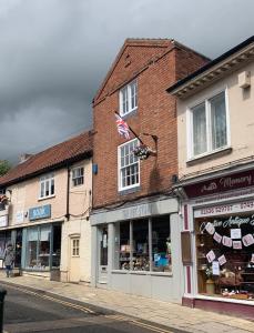 a building on a street with shops on it at RECENTLY RENOVATED property in the heart of Southwell in Southwell