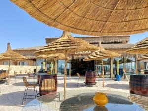 a group of straw umbrellas on a patio at Tulum Beach Resort Dakhla in Dakhla