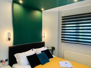 a bedroom with a green board above a bed at eliTe deluxe in Kavala