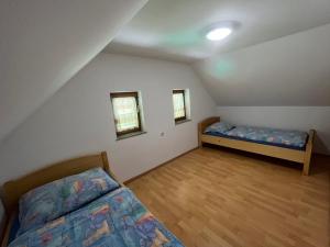 a bedroom with two beds in a attic at Holiday Home Dobrotin in Vojnik