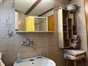 a bathroom with a sink and a mirror at Holiday Home Dobrotin in Vojnik