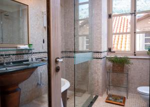 a bathroom with a glass shower and a sink at The Pucic Palace in Dubrovnik +37 photos