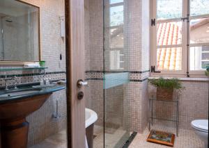 a bathroom with a glass shower and a sink at The Pucic Palace in Dubrovnik