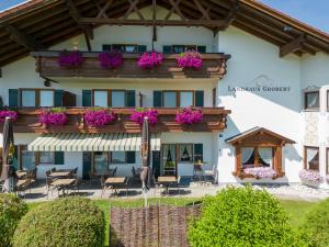 a building with a balcony with flowers on it at Landhaus Grobert in Seeg