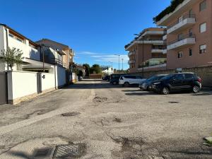 an empty parking lot with cars parked next to buildings at B&B Le Mansarde in Pescara