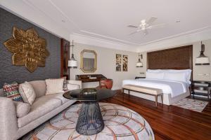 a living room with a bed and a couch at InterContinental Bali Resort by IHG in Jimbaran