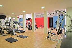 a gym with a bunch of treadmills and machines at Hotel Dann Cali in Cali